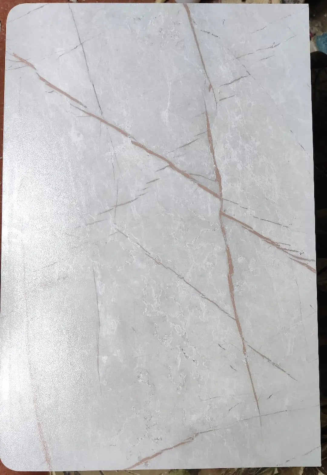 Marble-patterned surface with golden veins on a grey background